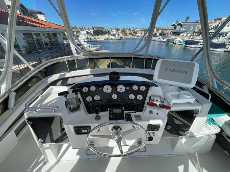 Slide: The Image of 1988 Trojan 12 Meter Convertible boat, upper deck view, clear skies. - 18