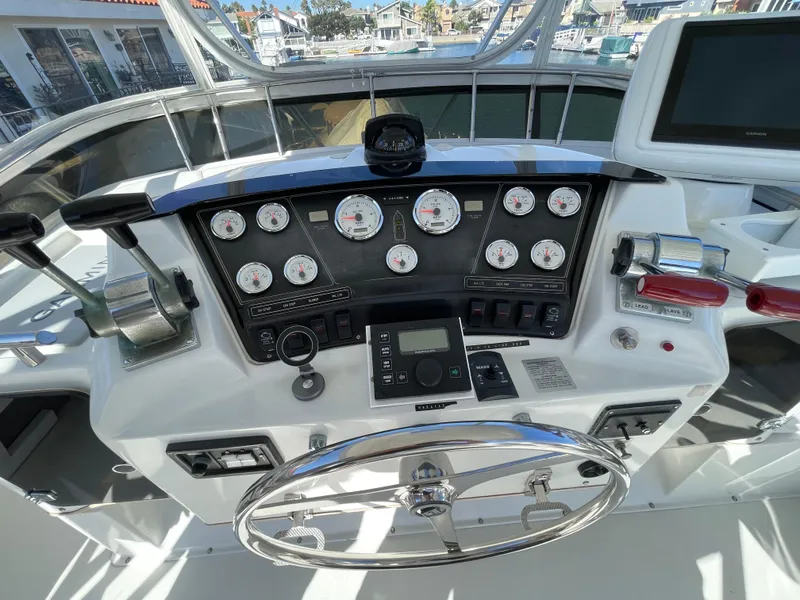 Slide: The Image of 1988 Trojan 12 Meter Convertible boat interior with helm seat and controls. - 20
