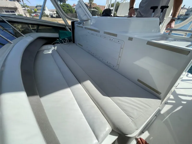 Slide: The Image of 1988 Trojan 12 Meter Convertible helm with Garmin navigation, overlooking marina. - 22