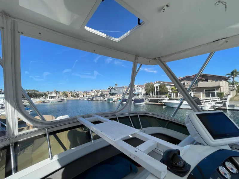 Slide: The Image of Control panel of a 1988 Trojan 12 Meter Convertible boat with gauges and steering wheel. - 24