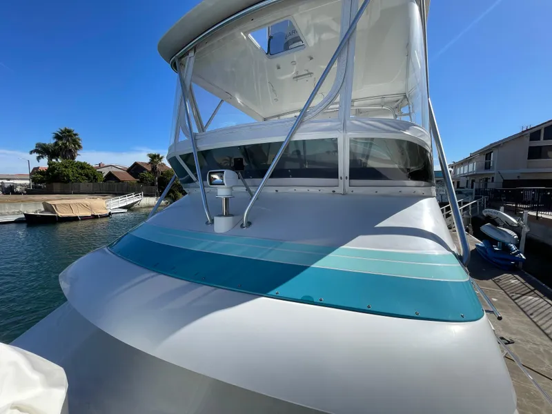 Slide: The Image of 1988 Trojan 12 Meter Convertible boat interior with marina view. - 27