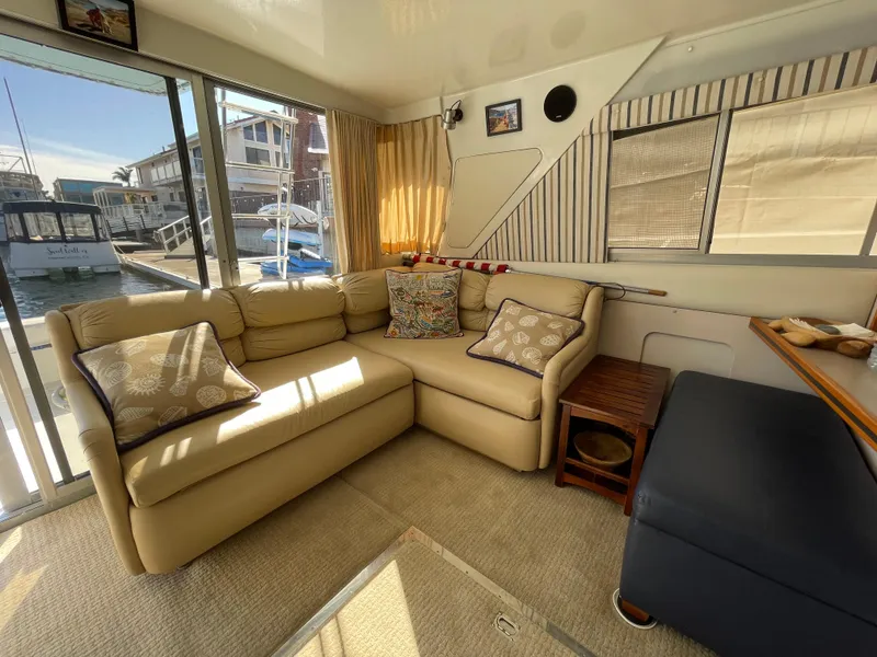 Slide: The Image of 1988 Trojan 12 Meter Convertible yacht on calm water, docked near waterfront homes. - 36