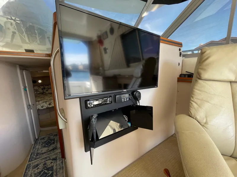 Slide: The Image of Luxurious 1988 Trojan 12 Meter Convertible yacht interior with plush seating and modern amenities. - 39