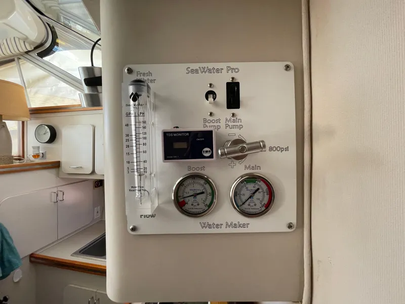 Slide: The Image of Control panel of a 1988 Trojan 12 Meter Convertible boat, featuring various switches and meters. - 45