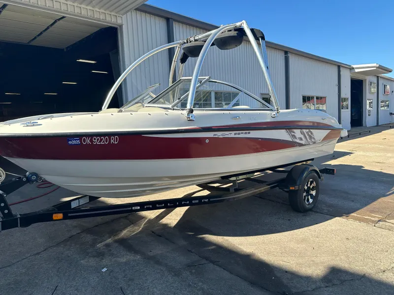Slide: The Image of 2011 Bayliner 185 boat on trailer, parked outside a garage. - 13