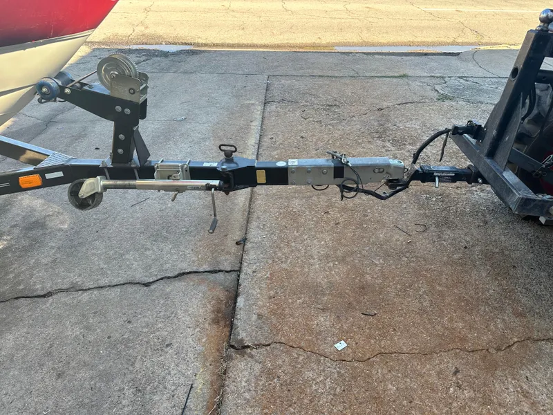Slide: The Image of 2011 Bayliner 185 boat trailer hitch connected to a vehicle on a concrete surface. - 17
