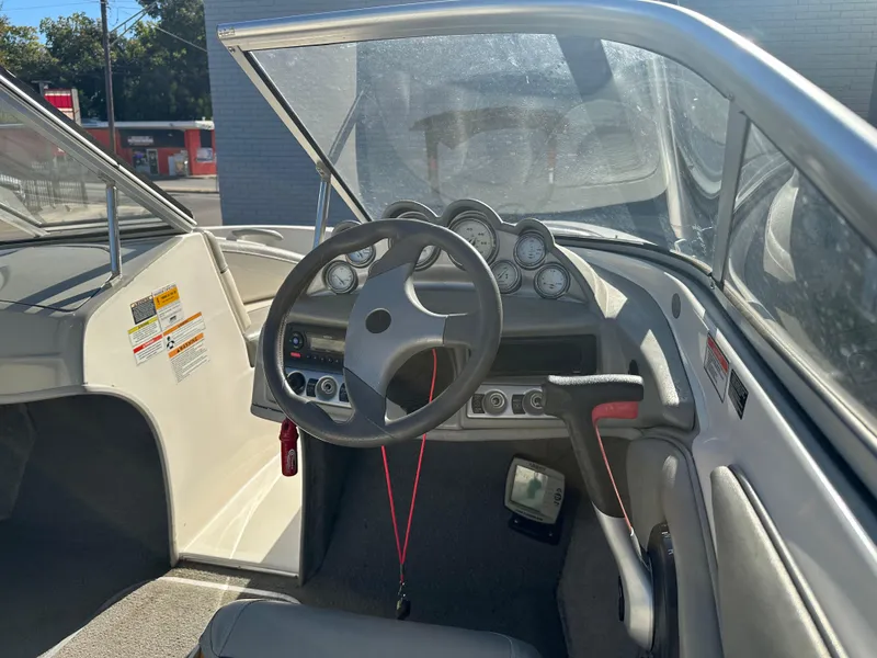 Slide: The Image of 2011 Bayliner 185 boat interior with steering wheel and dashboard controls. - 21