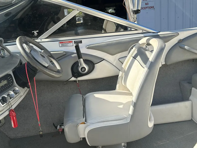 Slide: The Image of 2011 Bayliner 185 boat interior with steering wheel and seating. - 26
