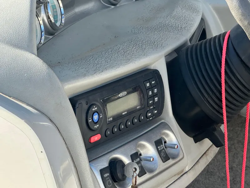 Slide: The Image of 2011 Bayliner 185 boat dashboard with radio and control switches. - 27