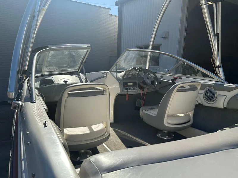 Slide: The Image of 2011 Bayliner 185 boat interior with steering wheel and seating. - 28