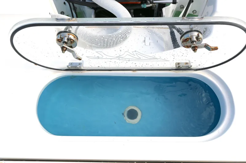 Slide: The Image of Livewell on 2021 Tidewater 2500 Carolina Bay boat, open lid, filled with water. - 10
