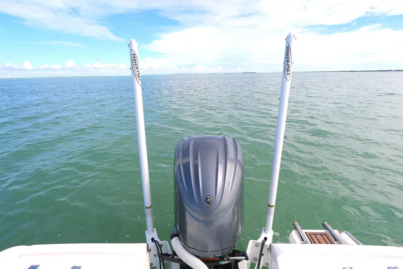 Slide: The Image of 2021 Tidewater 2500 Carolina Bay boat on open water, featuring a powerful outboard motor. - 11