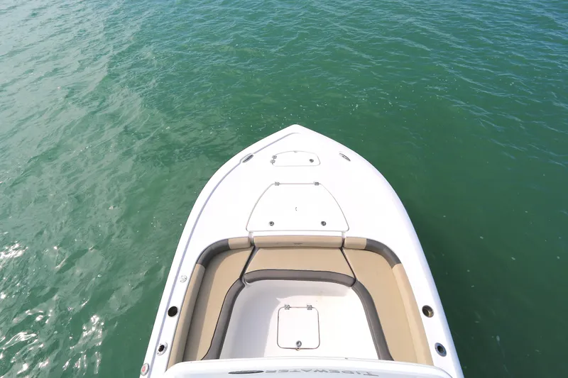 Slide: The Image of 2021 Tidewater 2500 Carolina Bay boat on clear green water, top view. - 13