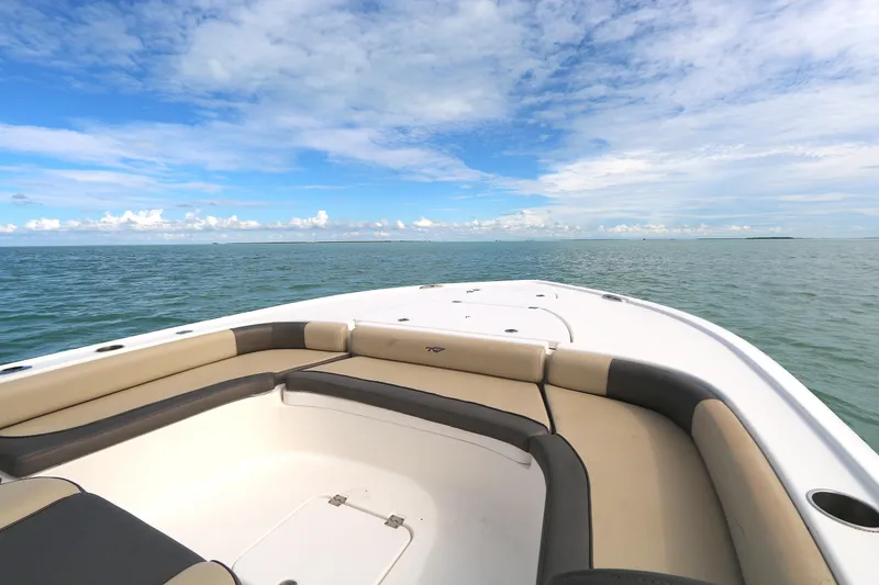 Slide: The Image of 2021 Tidewater 2500 Carolina Bay boat on open water under a blue sky. - 4