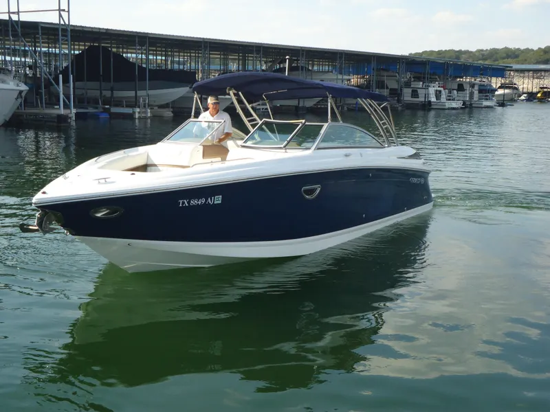 The Image of 2007 Cobalt 302 boat on water near marina, featuring sleek design and blue hull. - 1