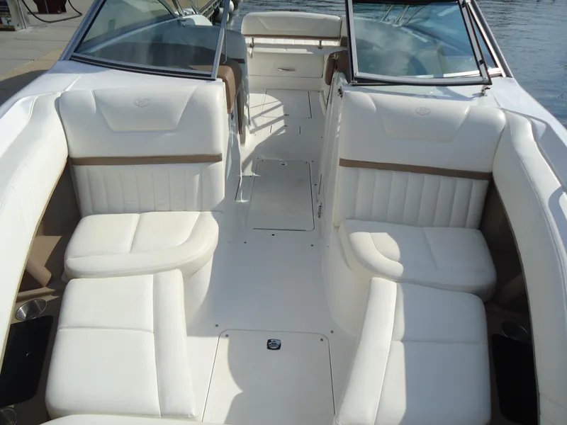Slide: The Image of 2007 Cobalt 302 boat interior with white leather seating and open cockpit design. - 11