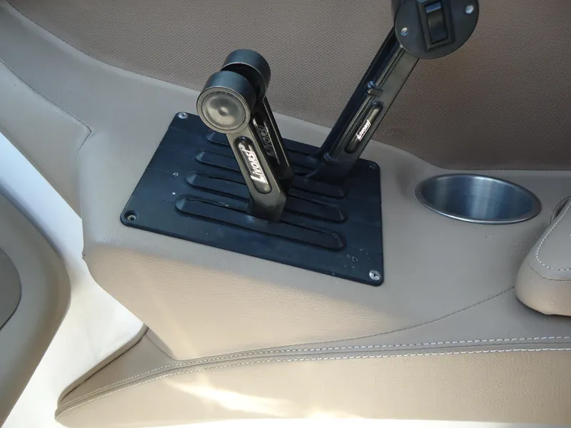 Slide: The Image of 2007 Cobalt 302 boat interior with dual throttle controls and cup holder. - 18