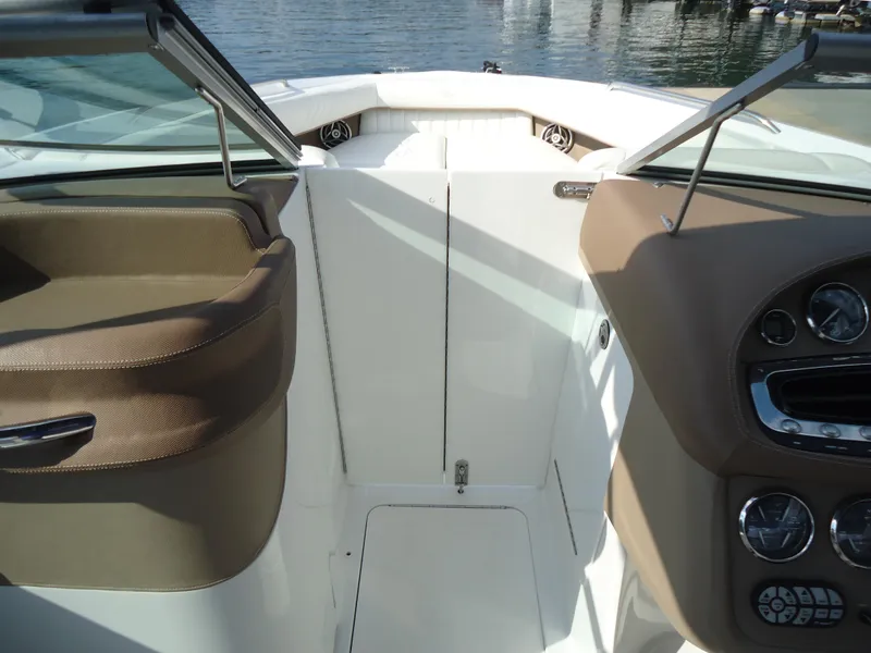 Slide: The Image of 2007 Cobalt 302 boat interior with dashboard and seating, docked by the water. - 22