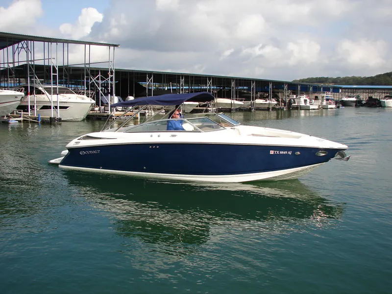 Slide: The Image of 2007 Cobalt 302 boat docked in a marina with calm waters. - 33