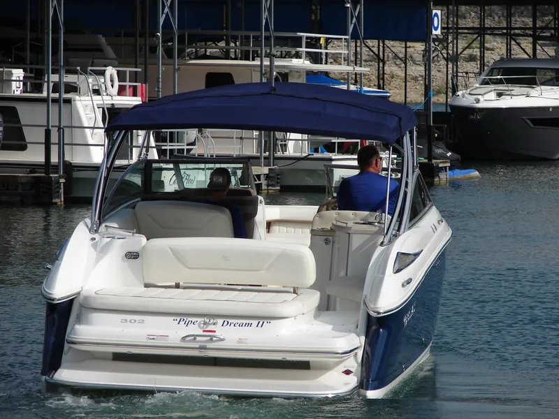 Slide: The Image of 2007 Cobalt 302 boat with blue canopy, docked in marina. - 41