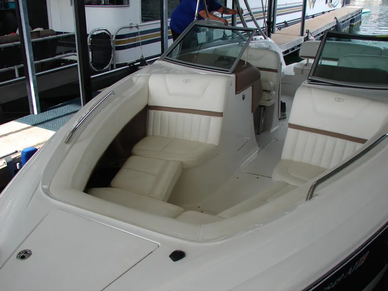 Slide: The Image of 2007 Cobalt 302 boat with white leather seating, docked at a marina. - 43