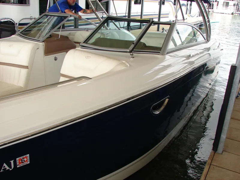 Slide: The Image of 2007 Cobalt 302 boat docked, featuring sleek design and spacious seating. - 44