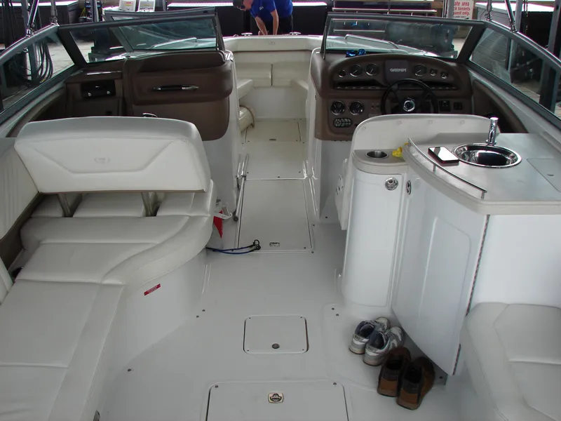 Slide: The Image of Interior of a 2007 Cobalt 302 boat with white seating and dashboard. - 46