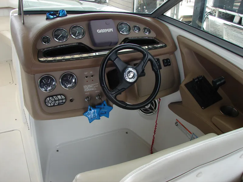 Slide: The Image of 2007 Cobalt 302 boat dashboard with Garmin navigation system and steering wheel. - 48