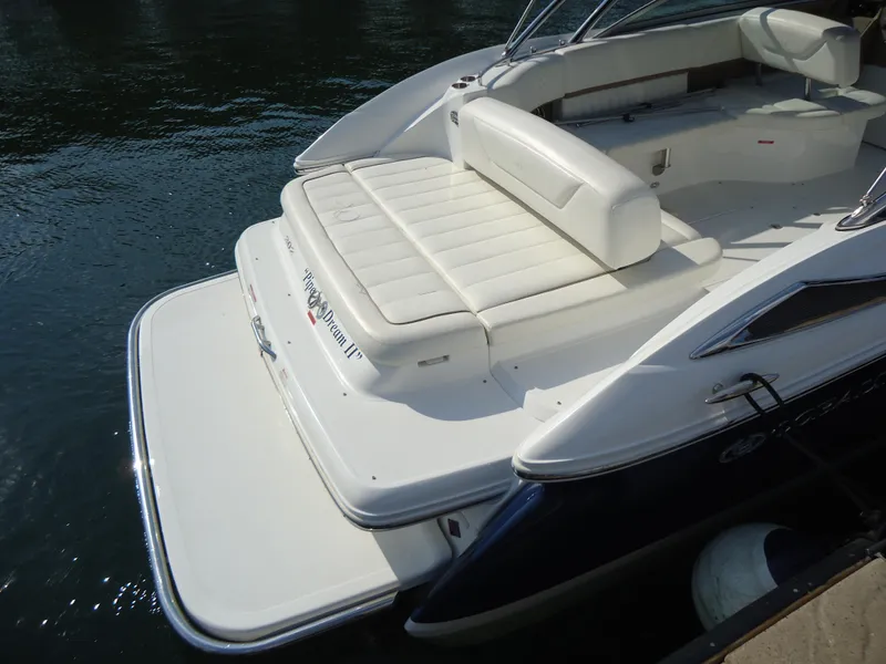 Slide: The Image of 2007 Cobalt 302 boat with white seating and swim platform on calm water. - 5