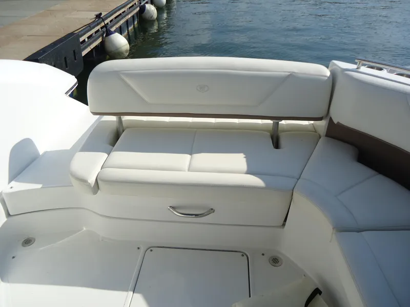 Slide: The Image of 2007 Cobalt 302 boat with white leather seating by the water. - 6
