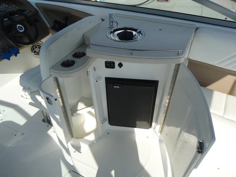 Slide: The Image of 2007 Cobalt 302 boat interior with sink, cup holders, and mini fridge. - 8