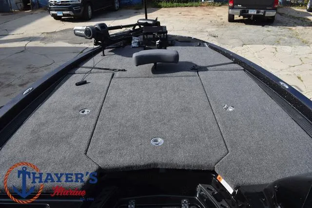 Slide: The Image of 2025 Ikon Boats VLX20 deck with carpeted surface and fishing equipment. - 10