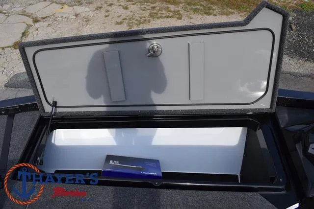 Slide: The Image of 2025 Ikon Boats VLX20 storage compartment with lock and manual inside. - 12