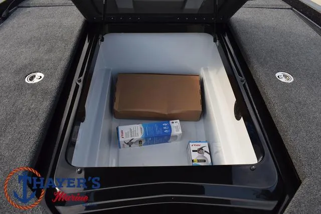 Slide: The Image of 2025 Ikon Boats VLX20 storage compartment with boxes, Thayer's Marine logo visible. - 13