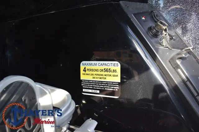 Slide: The Image of 2025 Ikon Boats VLX20 capacity label, 4 persons or 565 lbs, displayed on black surface. - 26