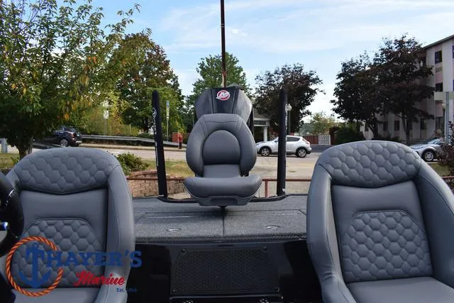 Slide: The Image of 2025 Ikon Boats VLX20 interior with gray seating and outdoor background. - 28