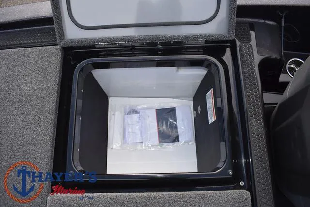 Slide: The Image of 2025 Ikon Boats VLX20 storage compartment with documents inside, featuring Thayer's Marine logo. - 30