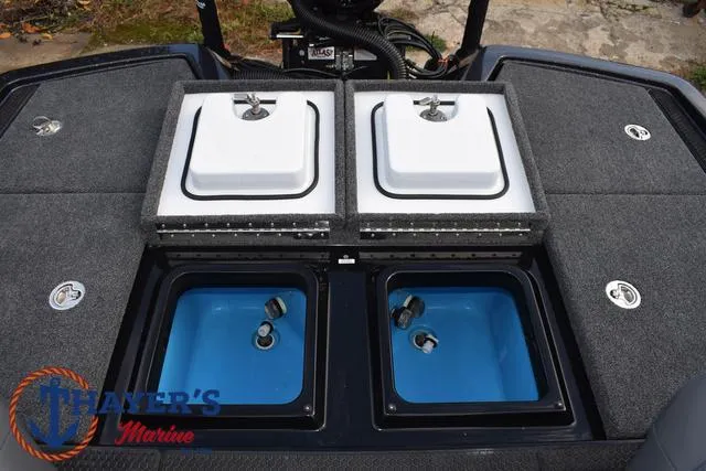 Slide: The Image of 2025 Ikon Boats VLX20 livewell compartments with lids open, showcasing interior features. - 31