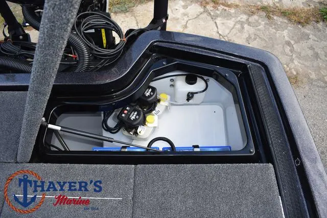 Slide: The Image of 2025 Ikon Boats VLX20 storage compartment with wiring and equipment, Thayer's Marine logo visible. - 32
