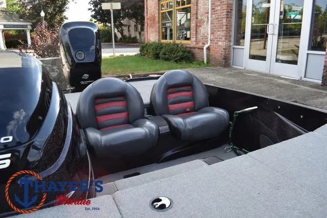 Slide: The Image of 2011 Nitro Z Series Z-6 boat with dual seats and Mercury engine, parked outside. - 12