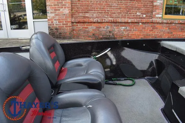 Slide: The Image of 2011 Nitro Z Series Z-6 boat interior with leather seats and brick wall background. - 13