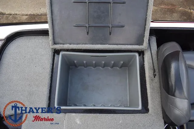 Slide: The Image of 2011 Nitro Z Series Z-6 boat storage compartment, open lid, gray interior, Thayer's Marine logo. - 20