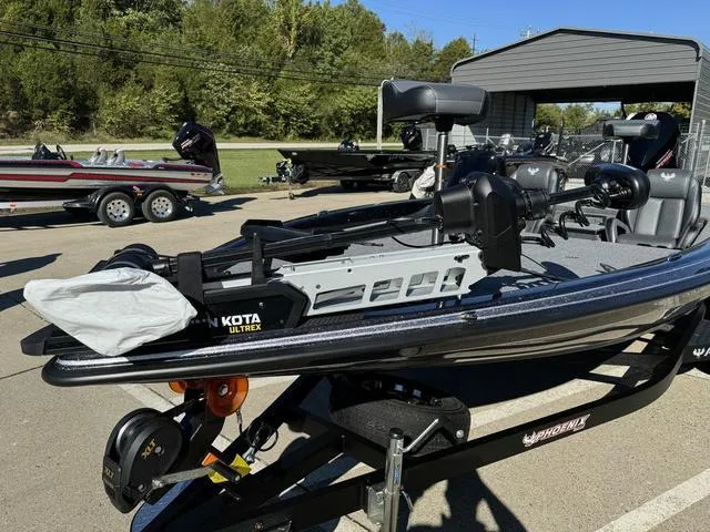 Slide: The Image of 2025 Phoenix 819 ZXL fishing boat with Minn Kota Ultrex motor in a parking lot. - 10