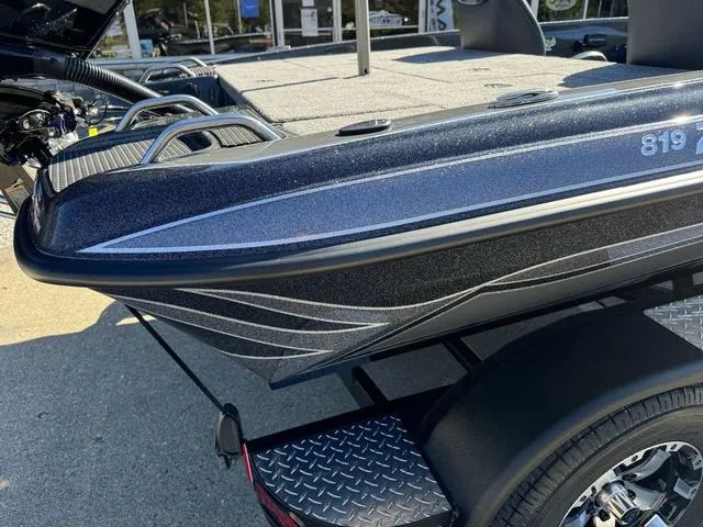 Slide: The Image of 2025 Phoenix 819 ZXL boat on trailer, featuring sleek design and metallic finish. - 5