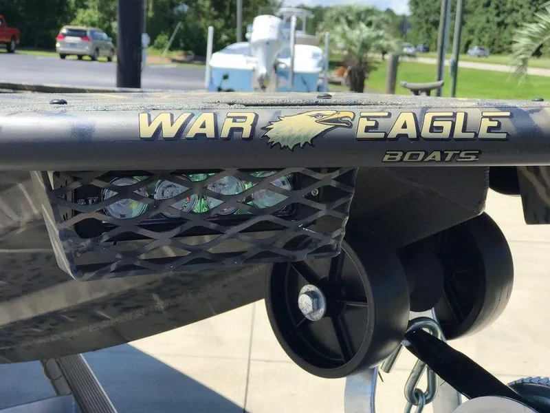 Slide: The Image of War Eagle Blackhawk 961 boat detail with logo and trailer, 2025 model. - 11