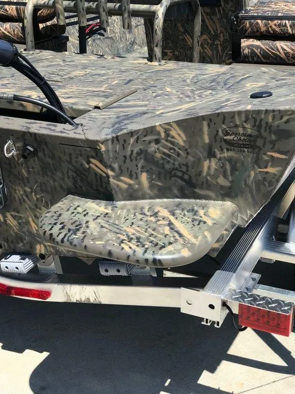 Slide: The Image of 2025 War Eagle Blackhawk 961 boat with camouflage design on a trailer. - 13