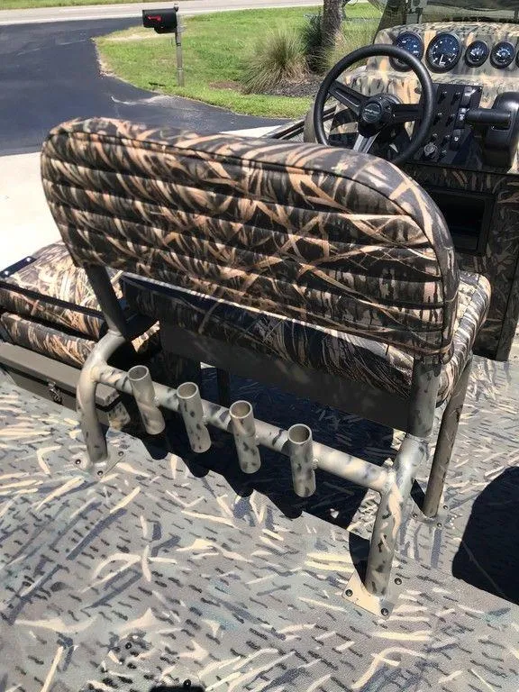 Slide: The Image of War Eagle Blackhawk 961 boat interior with camo seats and rod holders, 2025 model. - 3