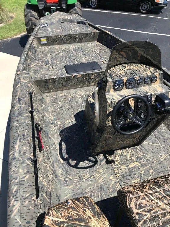Slide: The Image of 2025 War Eagle Blackhawk 961 boat with camouflage design and steering console. - 6