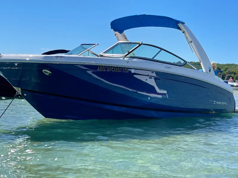 The Image of 2018 Regal 26 FasDeck boat in clear water, blue hull, sunny day. - 0