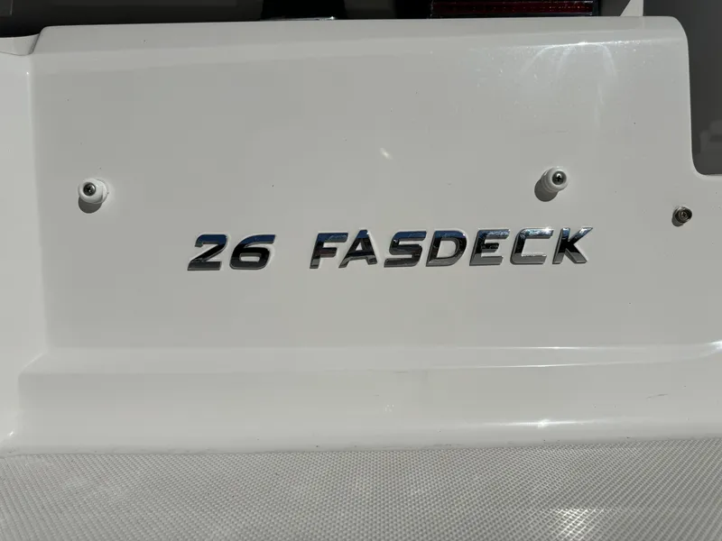 Slide: The Image of Regal 26 FasDeck 2018 model nameplate on white boat surface. - 12